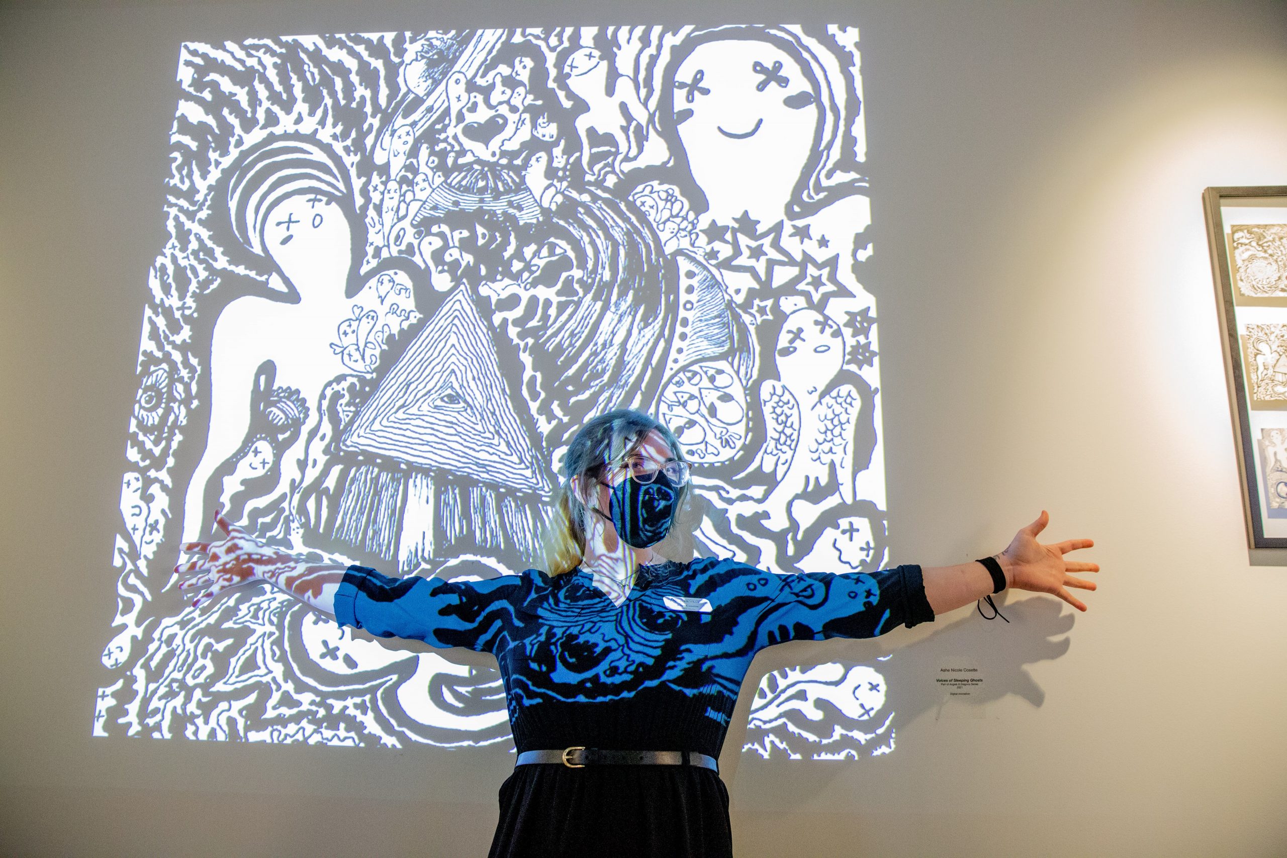Professor Ashe Cosette in front of her art