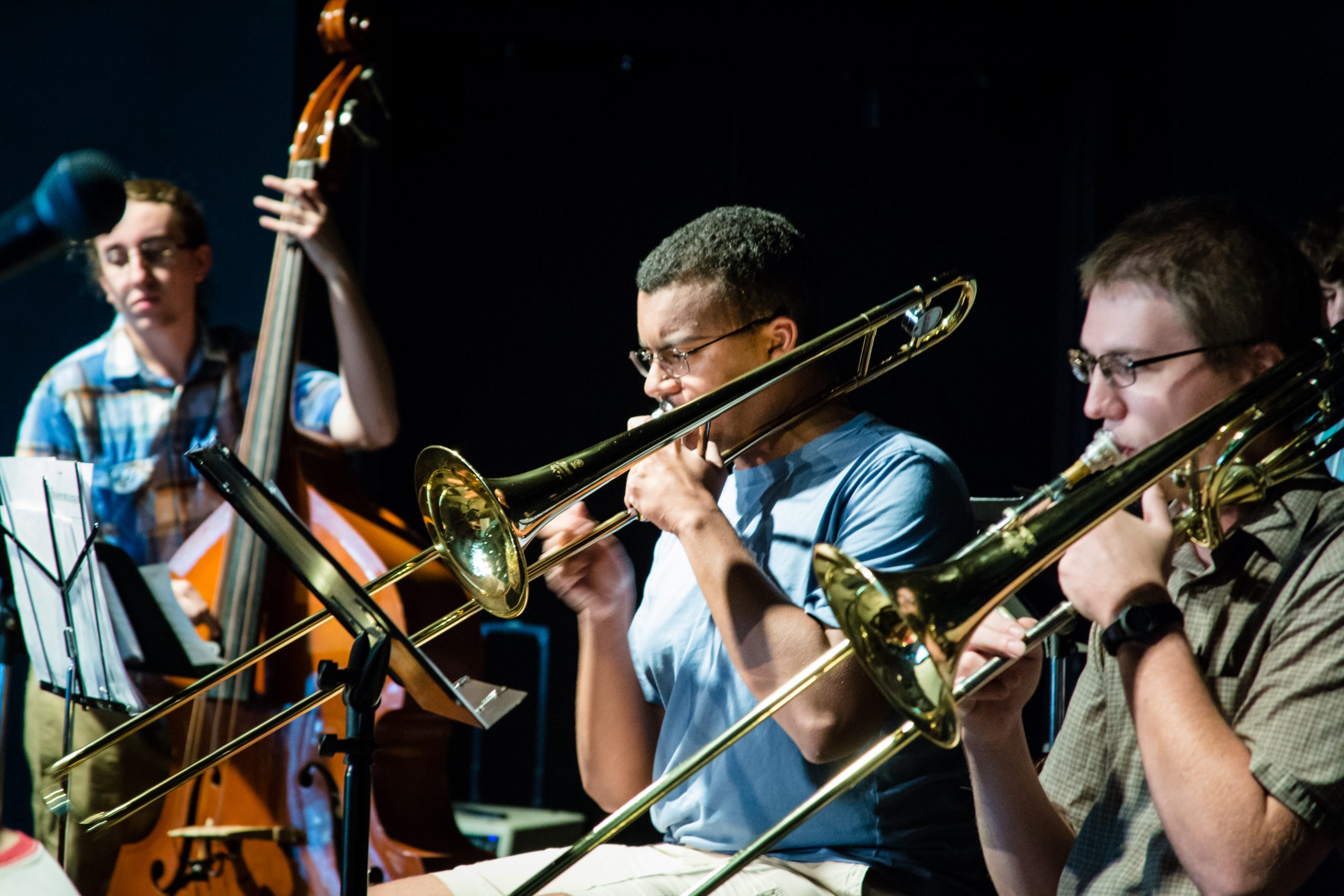 Students performing with brass and string instruments